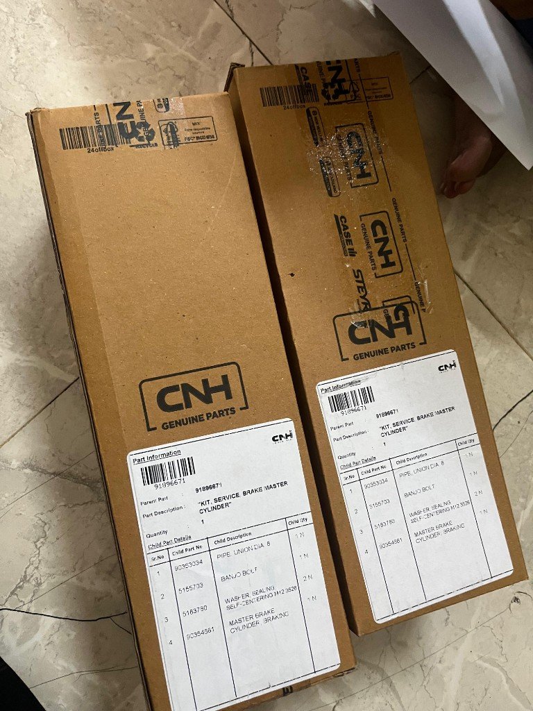 Case CNH 91896671 brake kit stacked boxes with CNH Genuine Parts labels — warehouse verification photo export FOB India