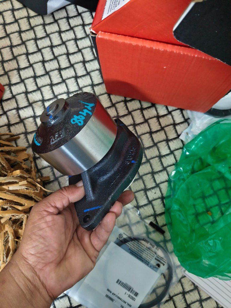 Cummins water pump held in hand with seal 3906698 bag — warehouse multi-angle photo Pioneer Mitra