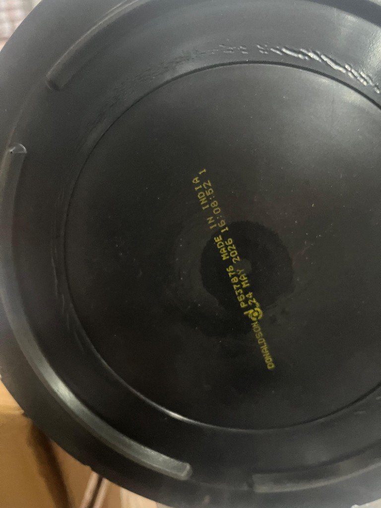 Donaldson P537876 engine air filter end cap label DONALDSON MADE IN INDIA production stamp — warehouse cross-reference photo