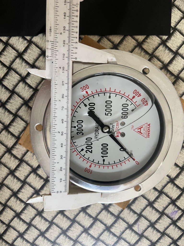 H. Guru India glycerine-filled hydraulic pressure gauge air bubble visible dial face caliper measurement ~150 mm — warehouse photo independent export supplier