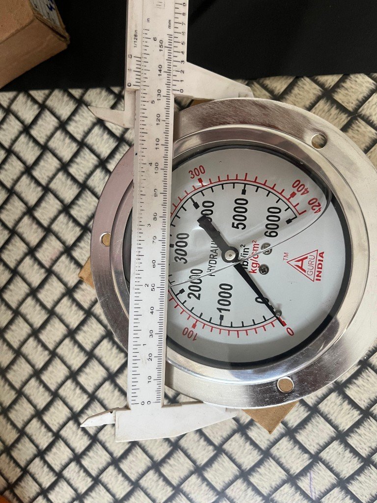 H. Guru India cross-reference 6-inch stainless steel hydraulic pressure gauge dial face GURU INDIA 6000 PSI 420 kg/cm² dual scale caliper ~150 mm — warehouse photo — Pioneer Mitra independent export supplier India