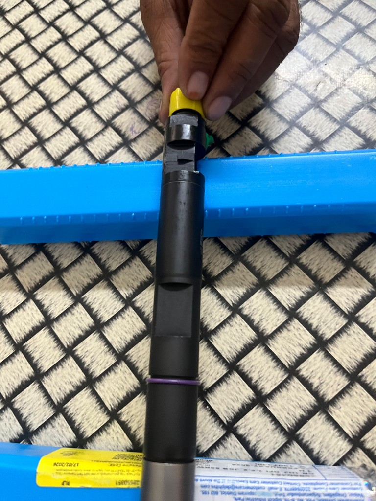 JCB 320/A6655 common rail injector close-up yellow protective cap purple O-ring seal — warehouse detail photo independent export supplier