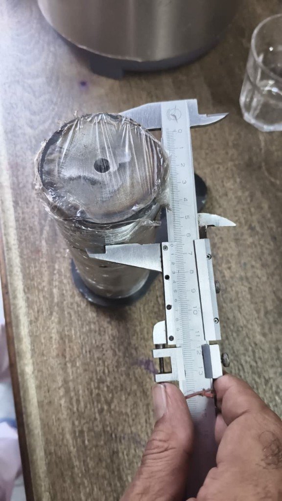 JCB 550/43110 axle pin caliper measurement 65 mm outer diameter — warehouse dimension verification photo Pioneer Mitra