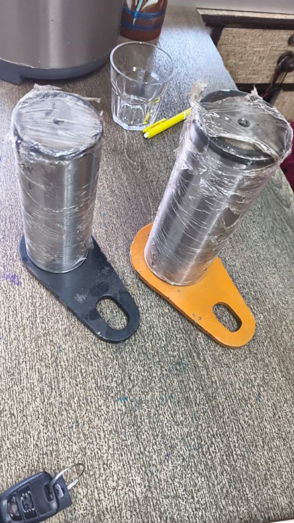 JCB cross-reference axle pin 550/43110 pair with black and orange base plates — warehouse photo — Pioneer Mitra independent export supplier India