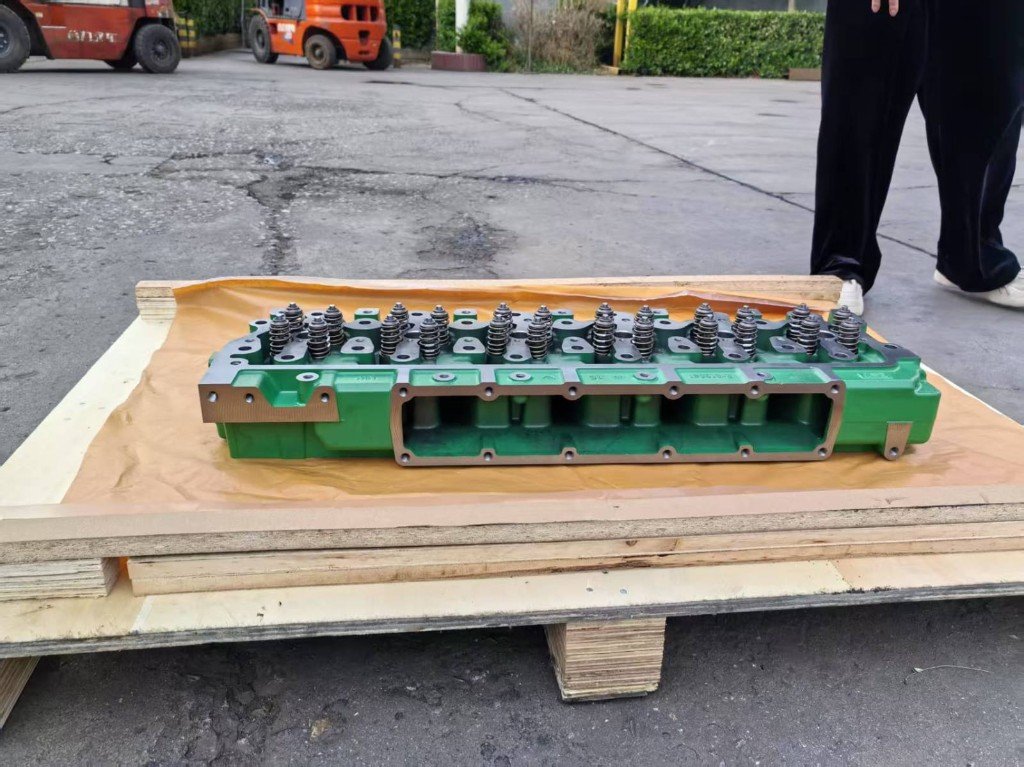 John Deere 6068-family cylinder head casting RE530113 with valve springs — source desk photo — Pioneer Mitra independent export supplier India