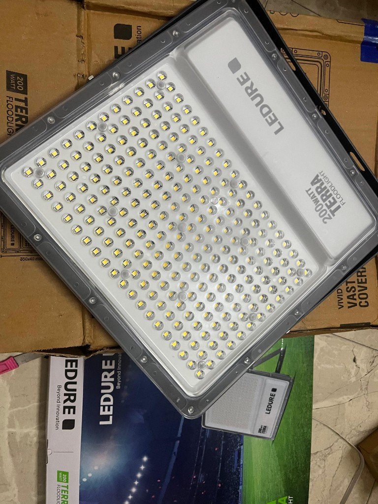 LEDURE Terra 200W floodlight angled view with packaging — same unit batch warehouse photo