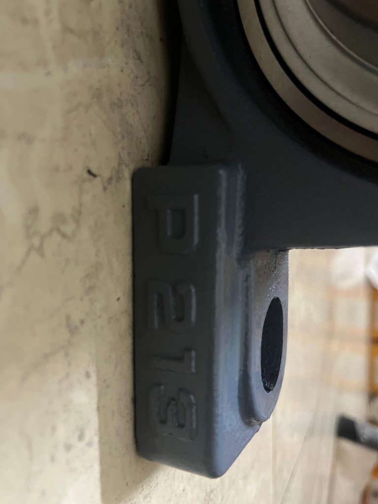 UCP213 P213 cast iron housing stamp embossed close-up 65mm bore — warehouse verification photo Pioneer Mitra