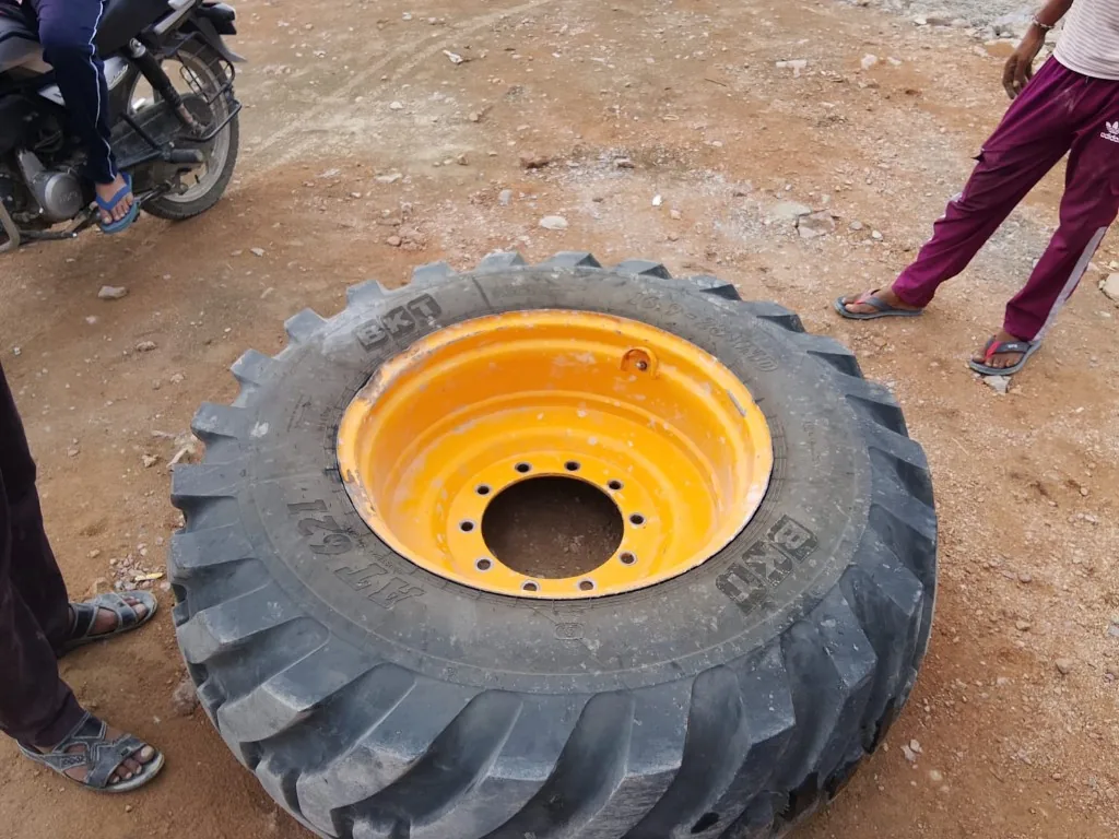 BKT AT621 16.9-28 IND industrial tyre on yellow 10-bolt rim — warehouse stock export from India