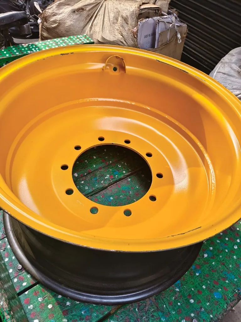 Yellow industrial rim angled view — 10-bolt mounting pattern valve stem tab warehouse photo
