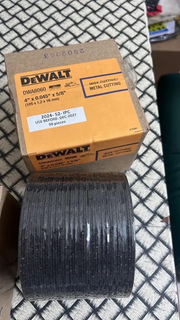DEWALT DWA8060 stack of 50 cutting wheels next to carton