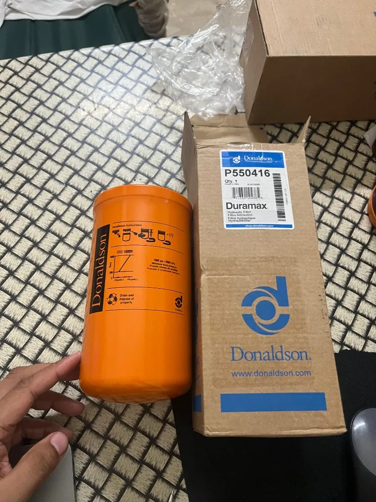 Donaldson P550416 Duramax filter held in hand — box label close-up shop.donaldson.com cross-reference warehouse photo