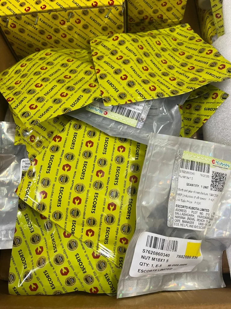 Multiple Escorts Kubota nuts in yellow Genuine Parts bags — warehouse fastener stock export photo
