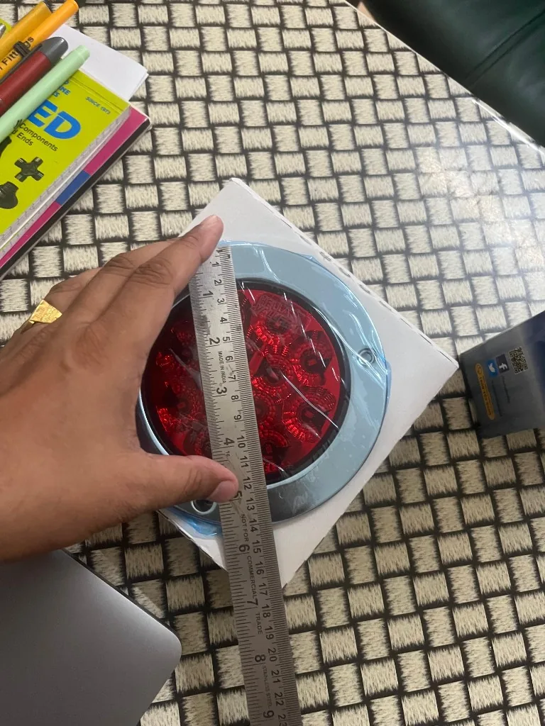 Hella VALUEFIT 328.870-08 red LED lens — 4 inch diameter ruler measurement embossed housing warehouse photo