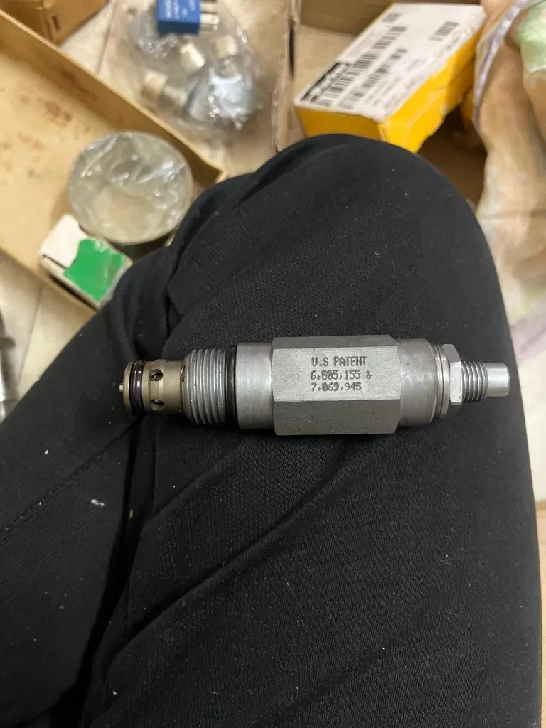 Screw-in cartridge relief valve side view nose orifices and adjuster stem