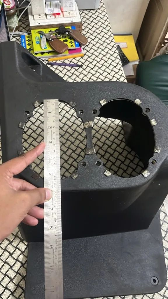 JCB instrument panel cover gauge opening — ruler showing approx 4.5 inch circular cutout twin gauge loader cover