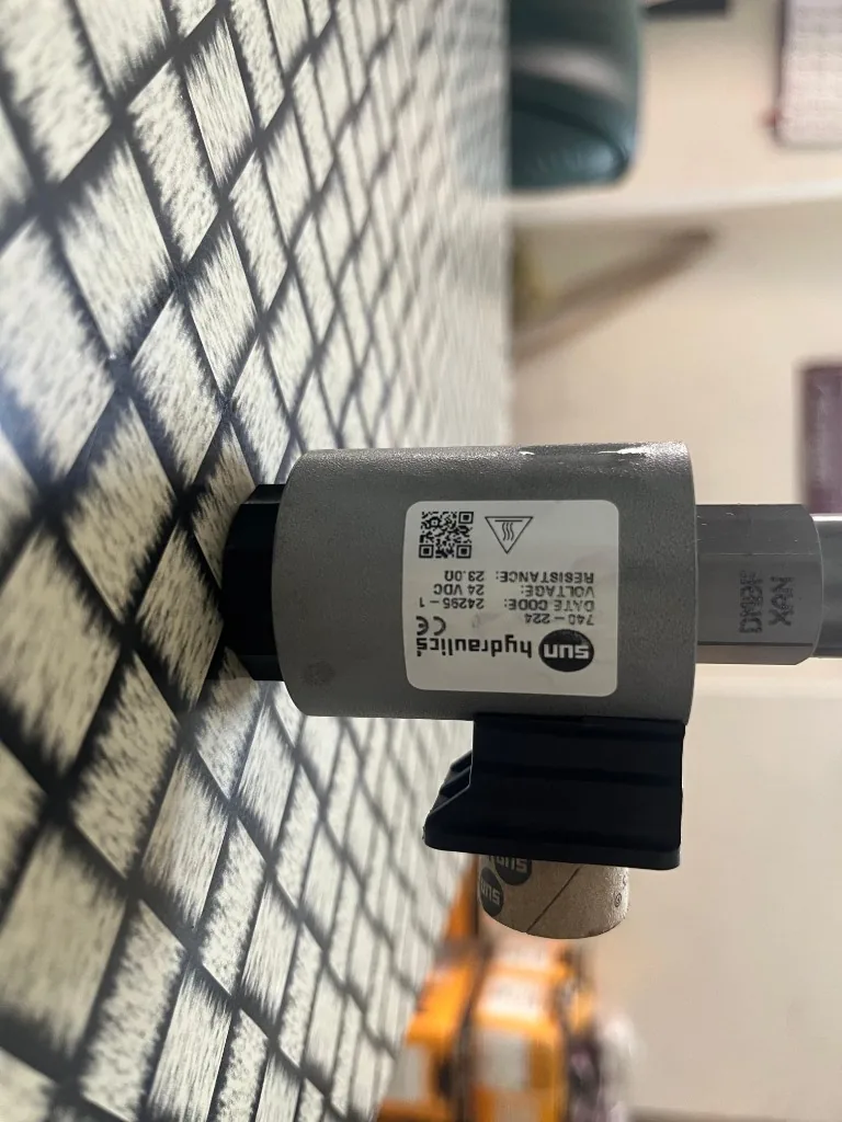 Part No. DMDAZBN224 solenoid coil label close-up — 24VDC 23.0 ohm Sun Hydraulics warehouse