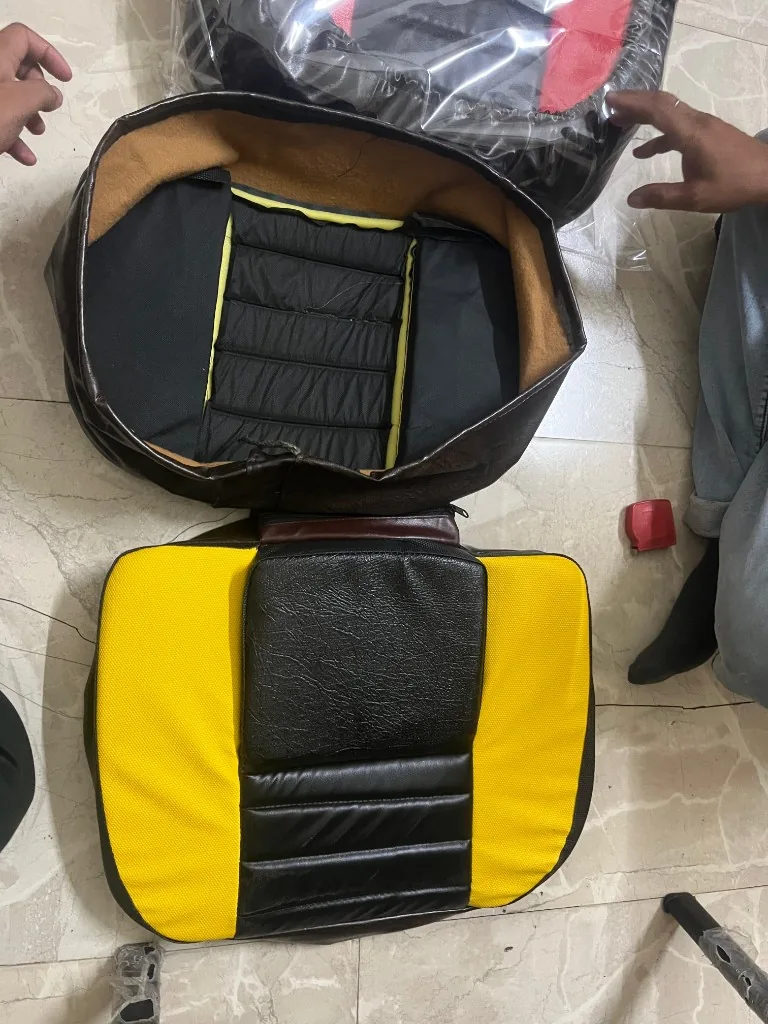Premium PU tractor seat cover two-piece set detail — zipper closure and padded cushion ribs warehouse photo