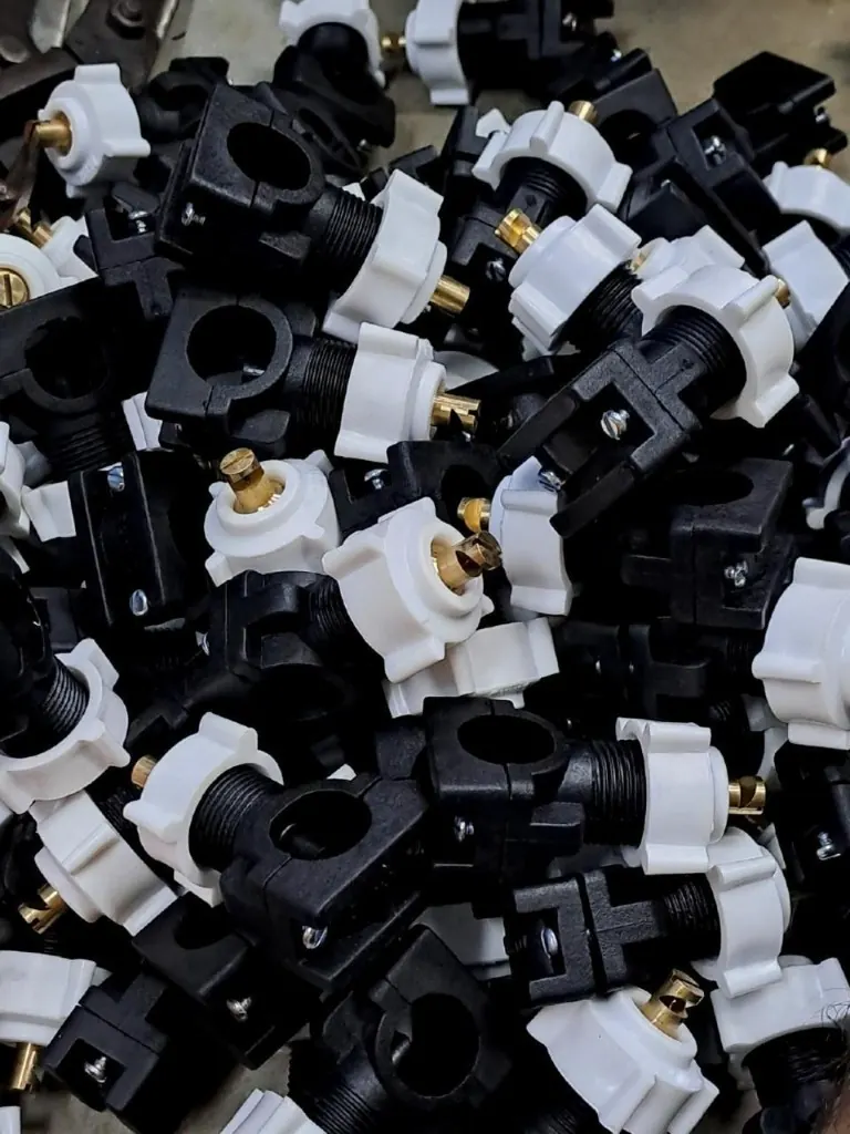 Black and white clamp-on spray nozzle bodies with brass tips