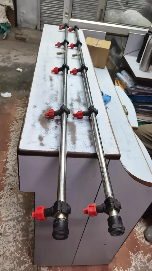 Two spray boom pipes with red shut-off valves