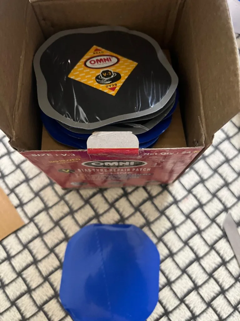 Omni Patch 3 open box — V-3 bias tyre repair patches blue adhesive back stack warehouse export photo New Delhi